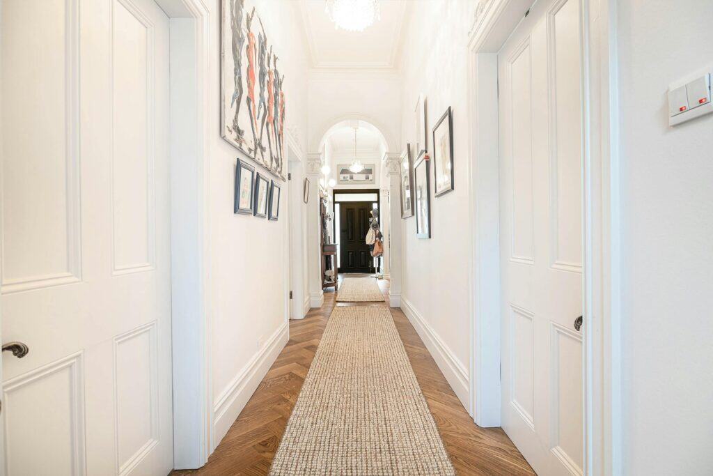 zipwp-image-17882087 Bright modern hallway in Melbourne home with contemporary artwork and stylish interior design.